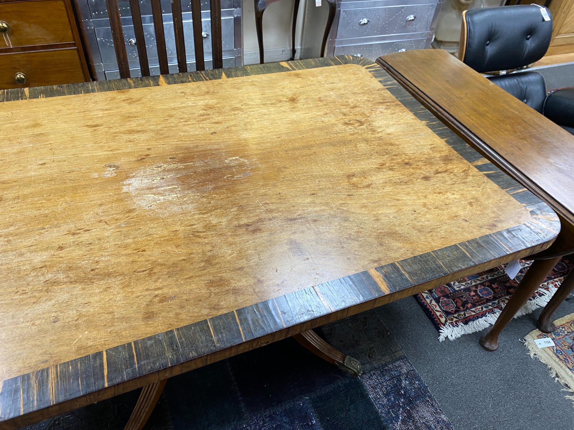 A Regency coromandel banded rectangular mahogany tilt top dining table, length 160cm, width 106cm, height 74cm